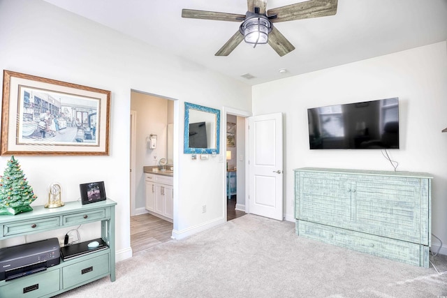 interior space with ceiling fan and light colored carpet