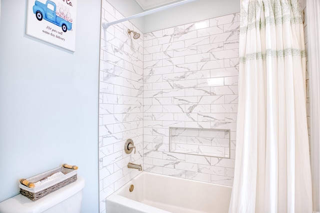 bathroom with shower / bath combo and toilet