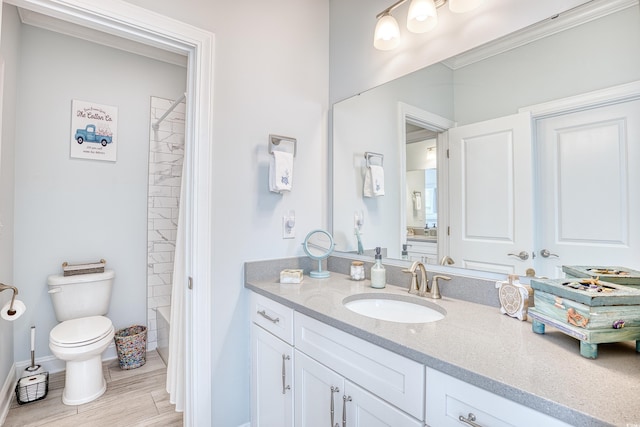 full bathroom featuring vanity,  shower combination, toilet, and crown molding