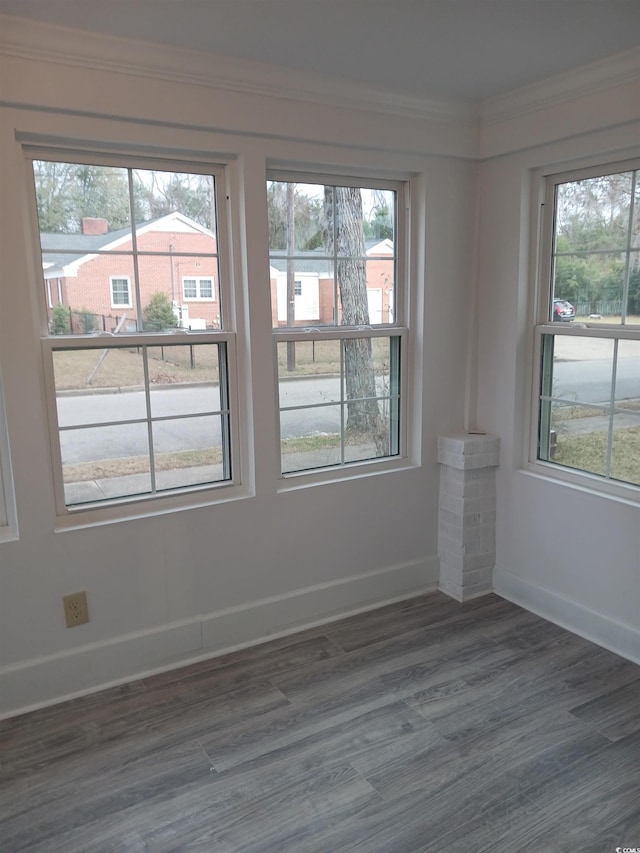 unfurnished room with dark hardwood / wood-style flooring and crown molding