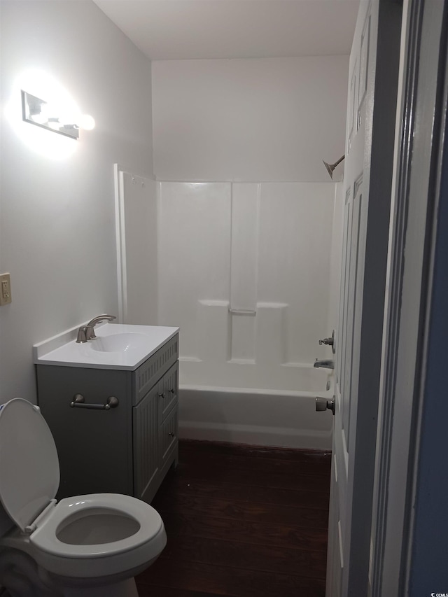 full bathroom featuring toilet, shower / bathing tub combination, hardwood / wood-style floors, and vanity