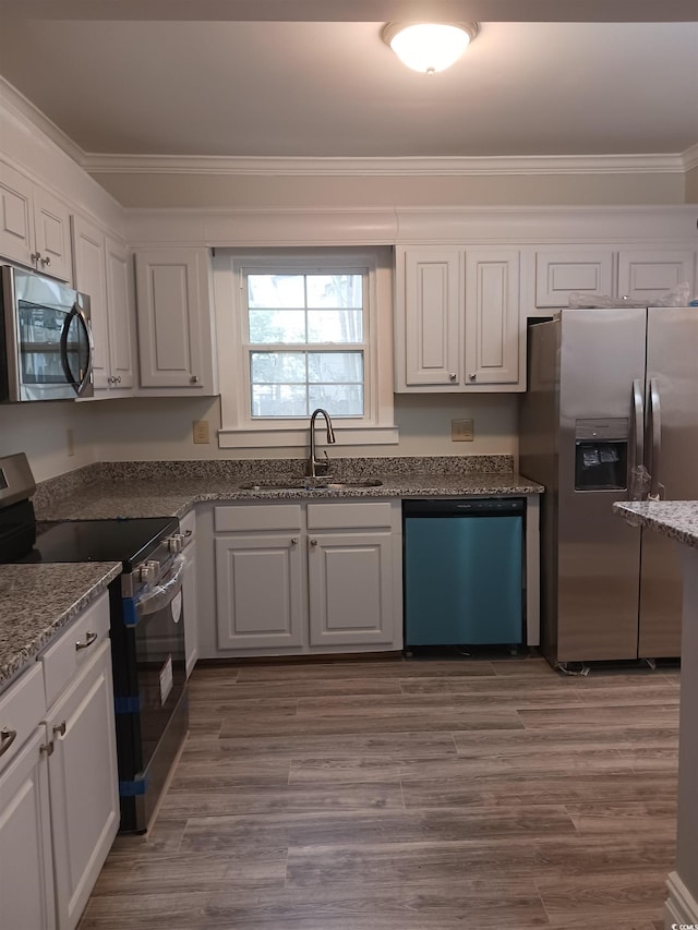 kitchen featuring white cabinets, appliances with stainless steel finishes, and sink