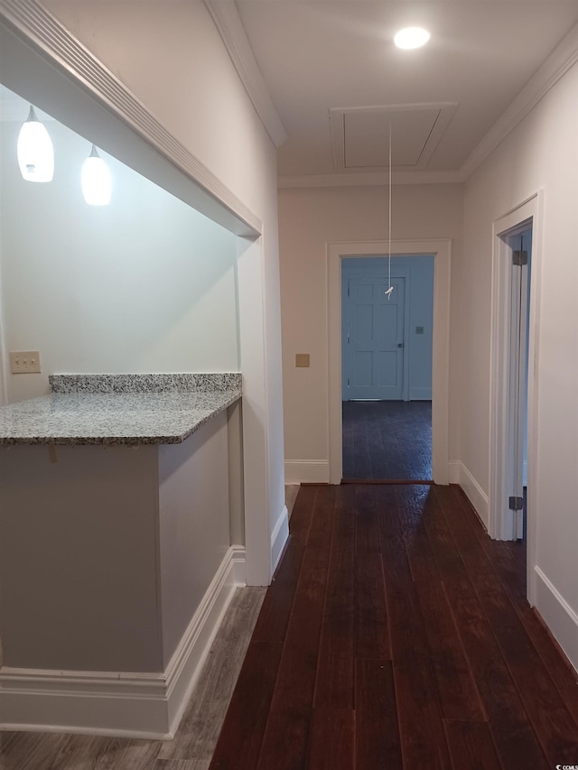 hallway featuring ornamental molding and dark hardwood / wood-style floors