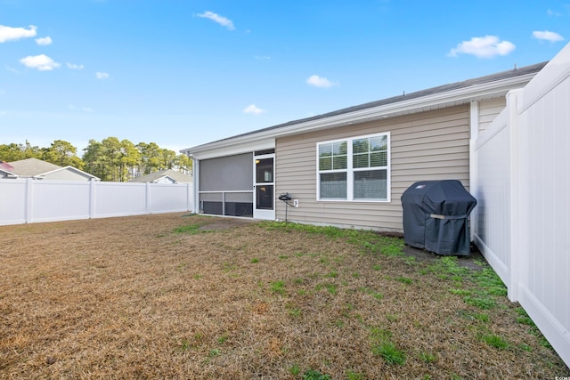 back of house featuring a sunroom and a yard