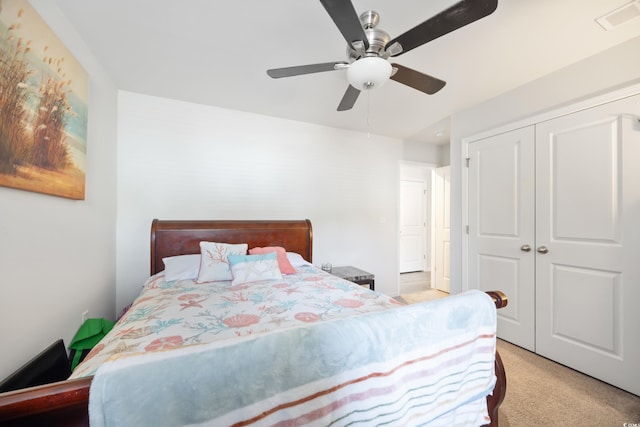 carpeted bedroom with a closet and ceiling fan