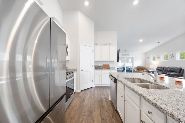 kitchen with sink, light stone countertops, appliances with stainless steel finishes, dark hardwood / wood-style flooring, and white cabinetry