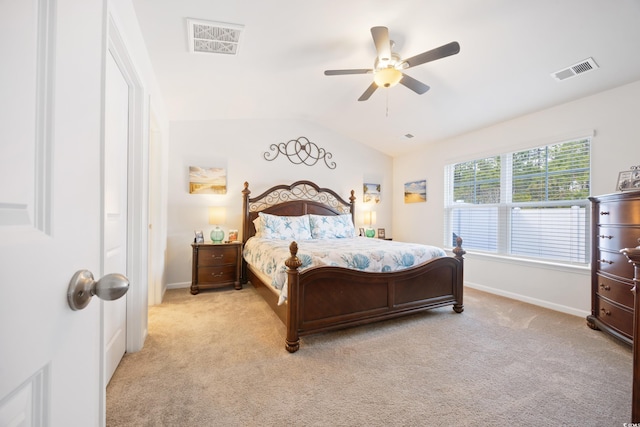 bedroom with light colored carpet, vaulted ceiling, and ceiling fan