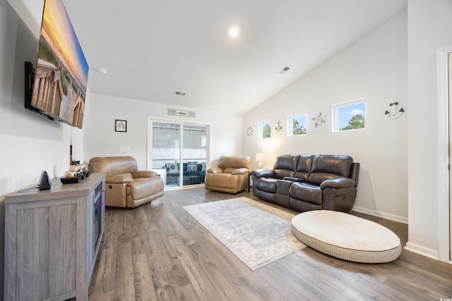 living room featuring hardwood / wood-style floors and vaulted ceiling