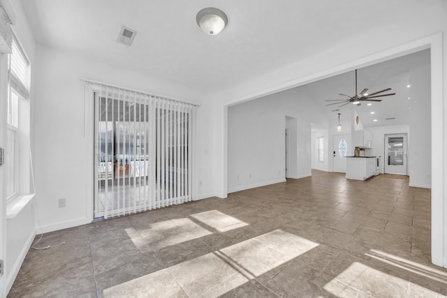 unfurnished living room featuring ceiling fan and lofted ceiling