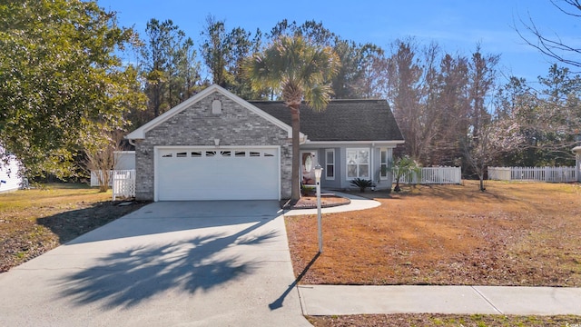 view of front of house featuring a garage and a front lawn