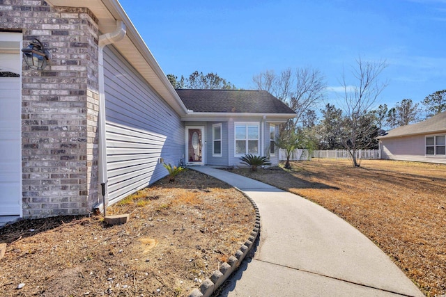 doorway to property featuring a yard