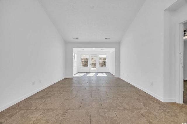 unfurnished living room with french doors and light tile patterned floors