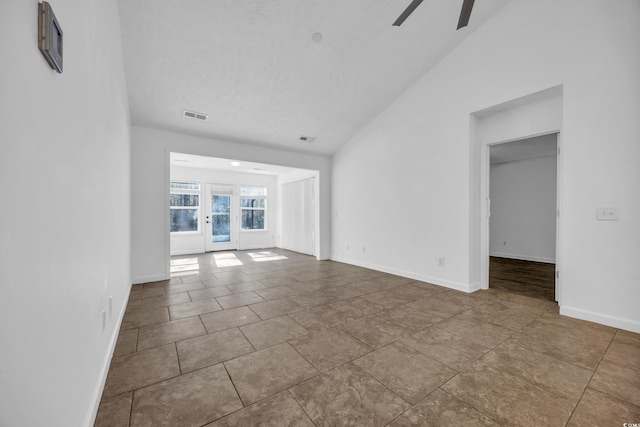 unfurnished living room featuring tile patterned floors, ceiling fan, and vaulted ceiling