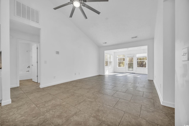 unfurnished living room featuring ceiling fan, light tile patterned floors, high vaulted ceiling, and french doors