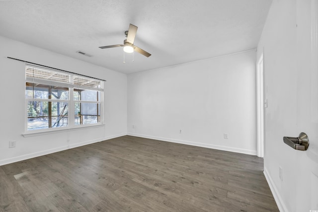 empty room featuring dark hardwood / wood-style flooring and ceiling fan