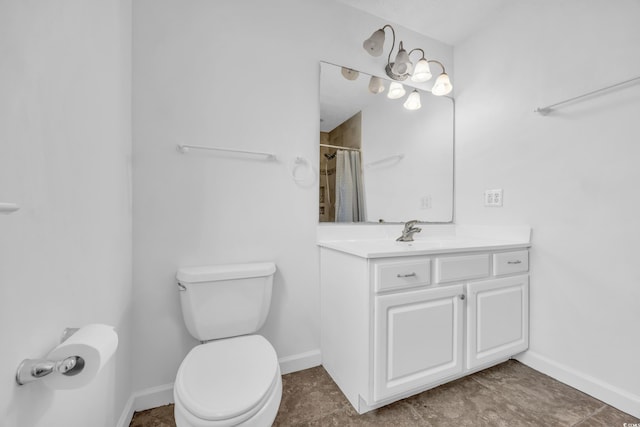 bathroom featuring curtained shower, vanity, and toilet