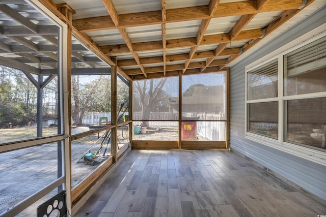 unfurnished sunroom with beam ceiling and coffered ceiling