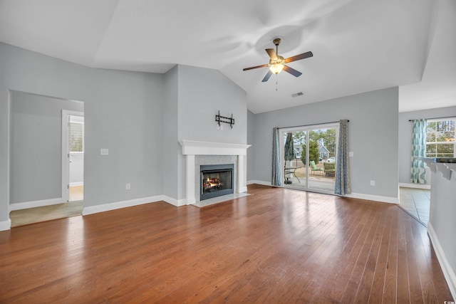 unfurnished living room featuring wood-type flooring, ceiling fan, and lofted ceiling