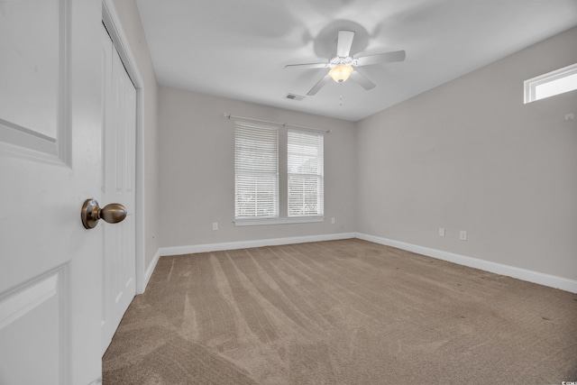 spare room with light carpet and ceiling fan