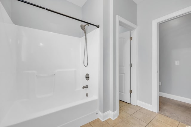 bathroom with tile patterned flooring and washtub / shower combination