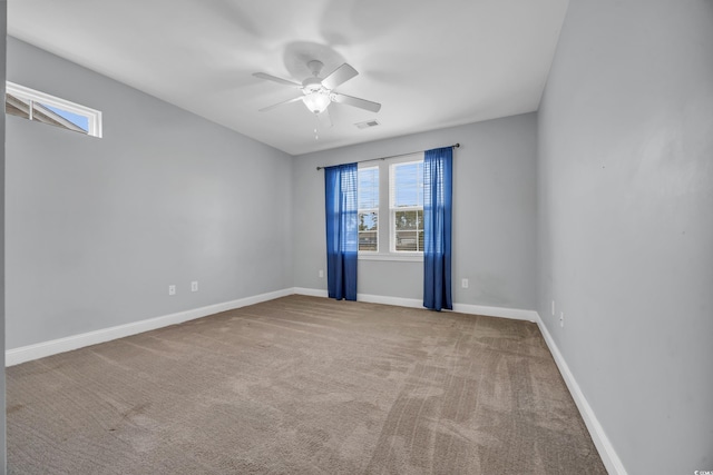 spare room featuring ceiling fan and carpet floors