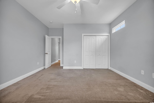 unfurnished bedroom with light carpet, a closet, and ceiling fan