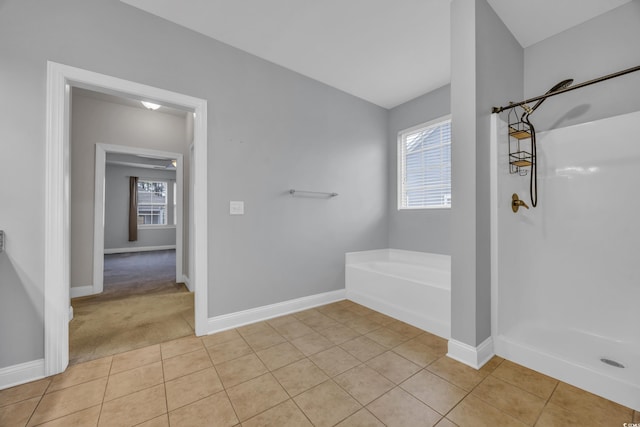 bathroom with tile patterned floors, plenty of natural light, and shower with separate bathtub