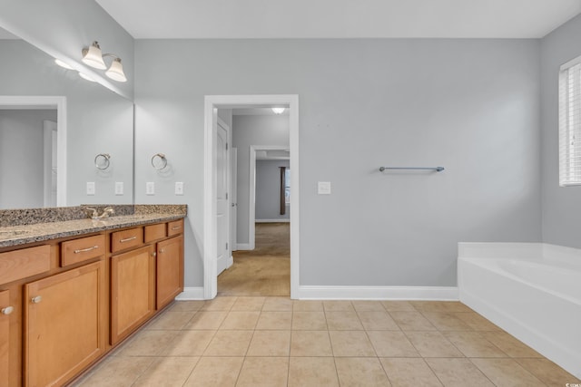 bathroom featuring tile patterned floors, a bathtub, and vanity