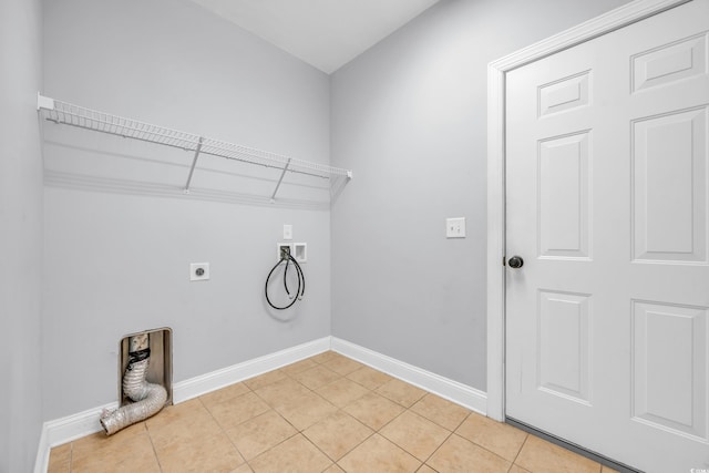 clothes washing area with hookup for an electric dryer, hookup for a washing machine, and light tile patterned floors