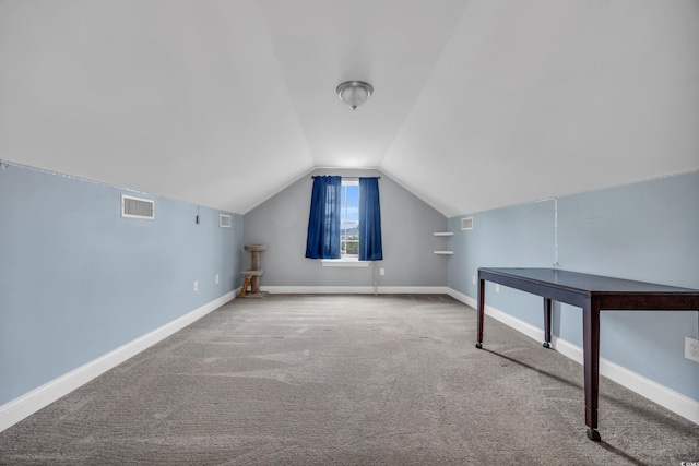 bonus room with carpet flooring and vaulted ceiling