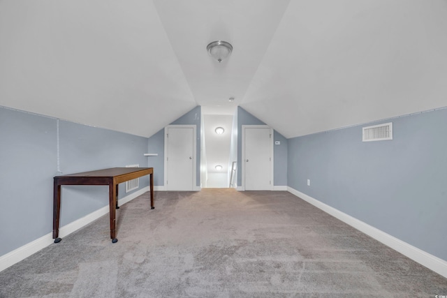 additional living space featuring light carpet and lofted ceiling