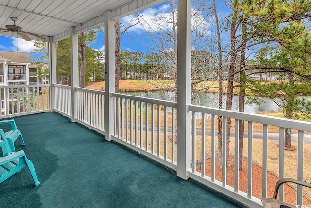 unfurnished sunroom featuring a water view