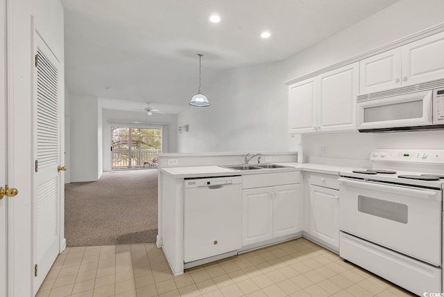 kitchen featuring kitchen peninsula, light colored carpet, white appliances, white cabinets, and pendant lighting