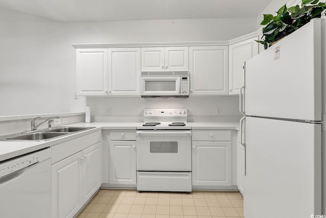 kitchen featuring light tile patterned flooring, sink, white appliances, and white cabinetry