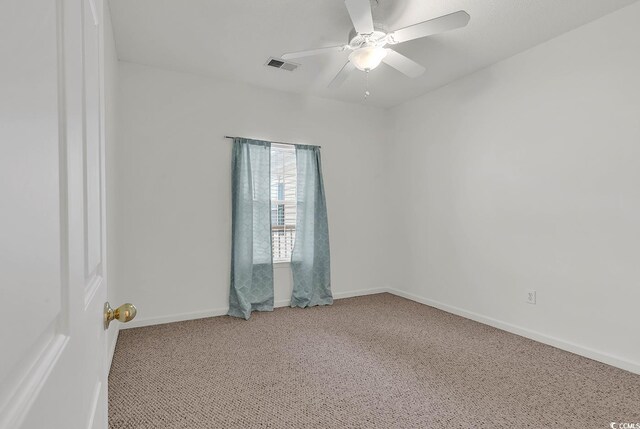 empty room featuring ceiling fan and carpet flooring