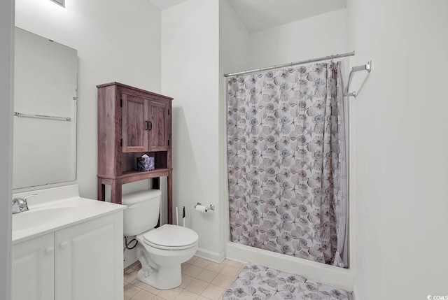 bathroom with toilet, vanity, tile patterned flooring, and a shower with curtain