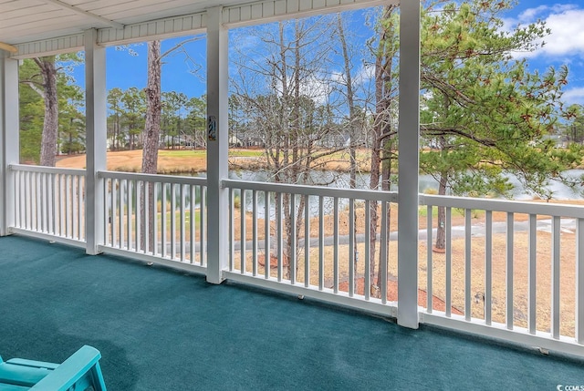 unfurnished sunroom featuring a water view