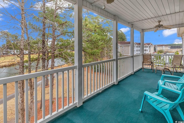 unfurnished sunroom featuring ceiling fan