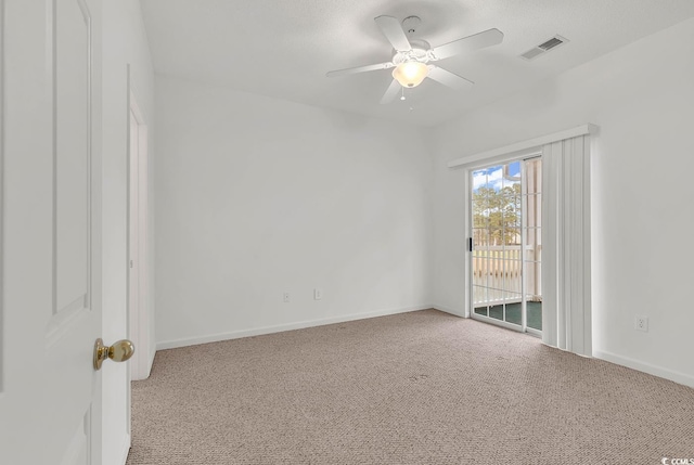 carpeted spare room with ceiling fan