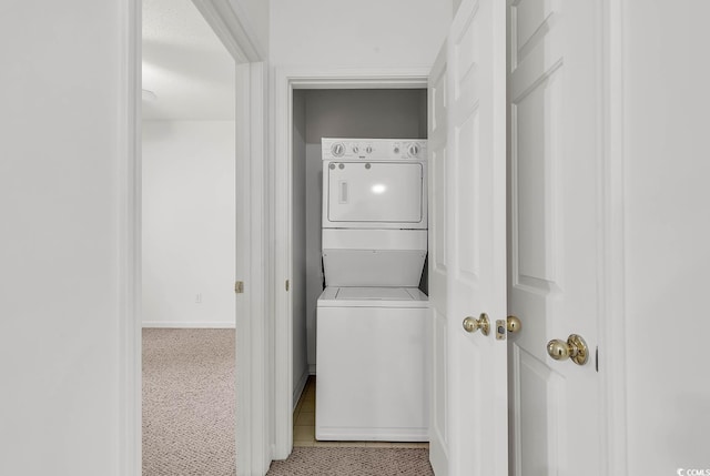 laundry area with stacked washing maching and dryer