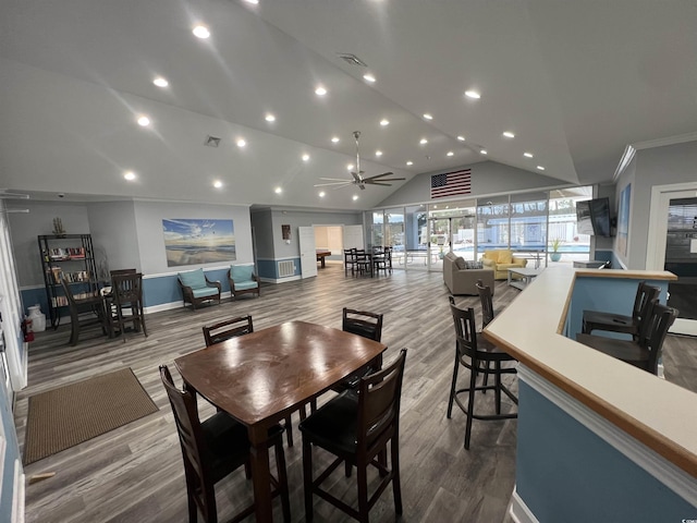 dining space featuring hardwood / wood-style flooring, ornamental molding, ceiling fan, and lofted ceiling