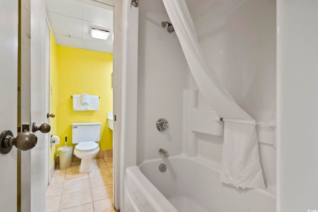 bathroom featuring toilet, tile patterned flooring, and shower / bath combination with curtain