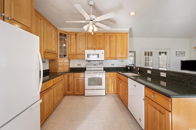 kitchen featuring tasteful backsplash, sink, dark stone countertops, ceiling fan, and white appliances