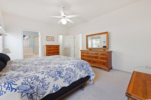 bedroom with light carpet, connected bathroom, and ceiling fan