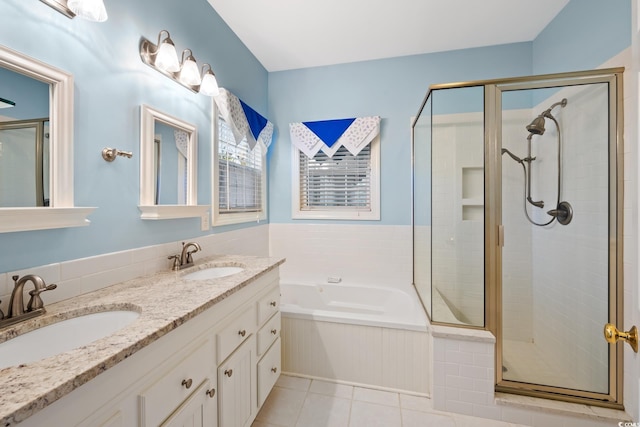 bathroom with independent shower and bath, vanity, and tile patterned floors