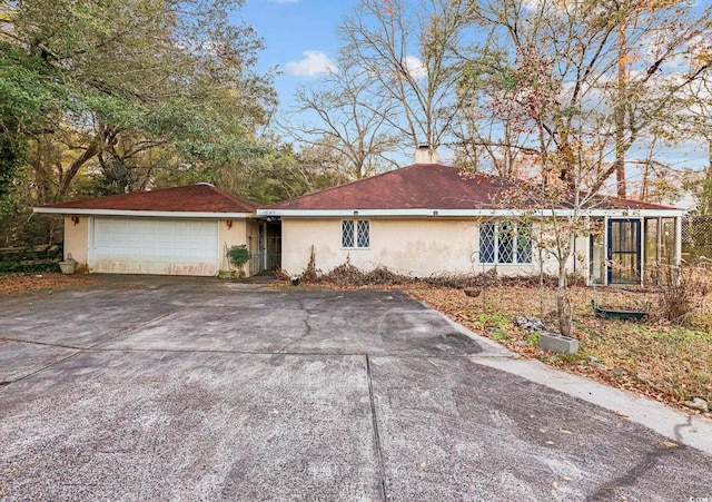 ranch-style home featuring a garage