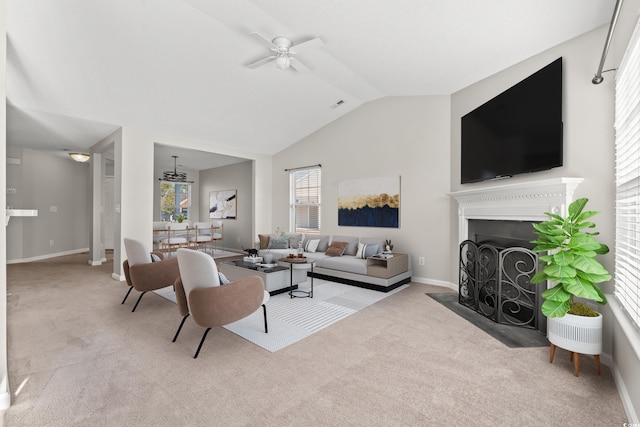 carpeted living room with ceiling fan and lofted ceiling