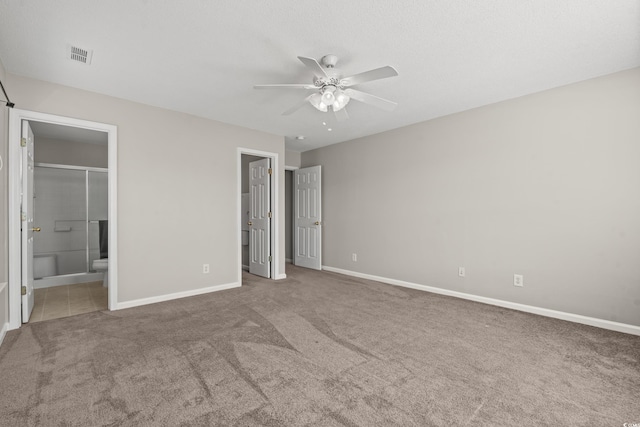 unfurnished bedroom with connected bathroom, ceiling fan, and carpet floors