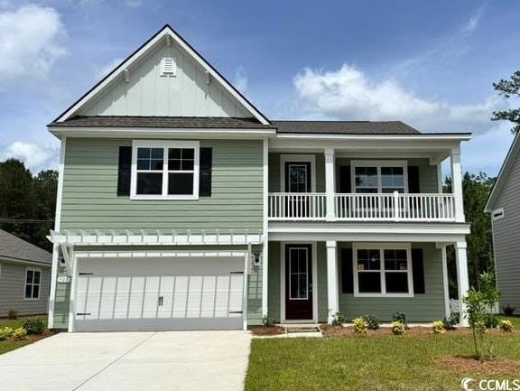 view of front of house with covered porch, a balcony, driveway, a garage, and board and batten siding
