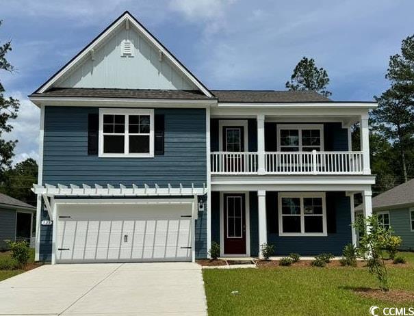 view of front of house featuring a balcony, concrete driveway, a garage, covered porch, and a front yard